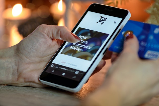 woman shopping online through her mobile phone